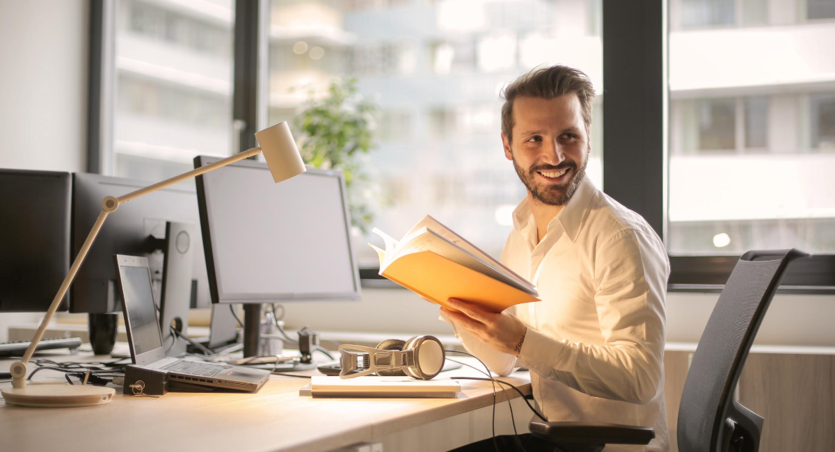 A man sitting at his office desk reviewing documents