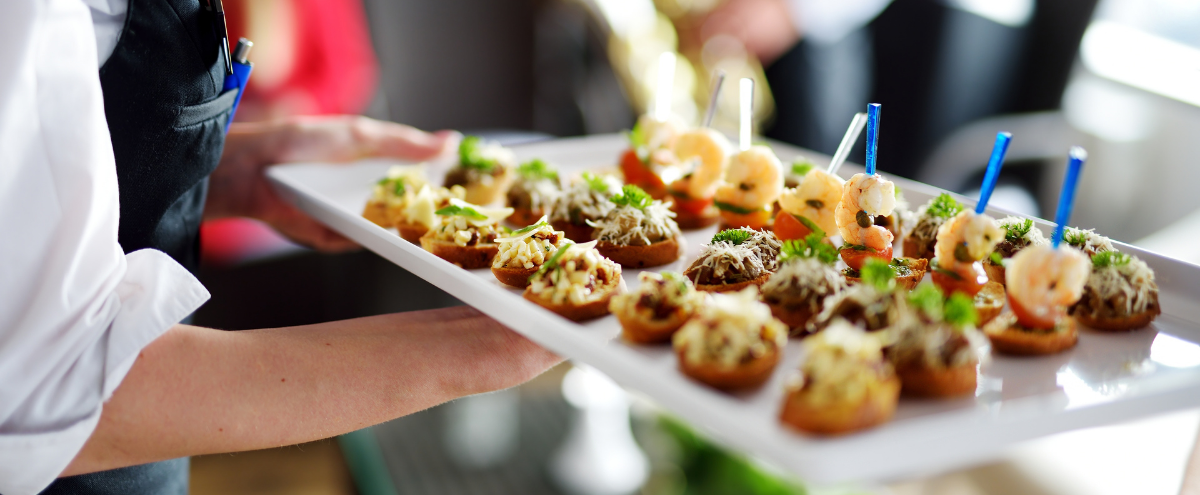 A Women Passing Out Appetizers