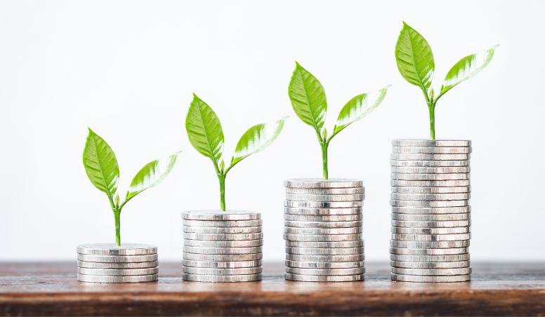Stacks of coins with sprouts