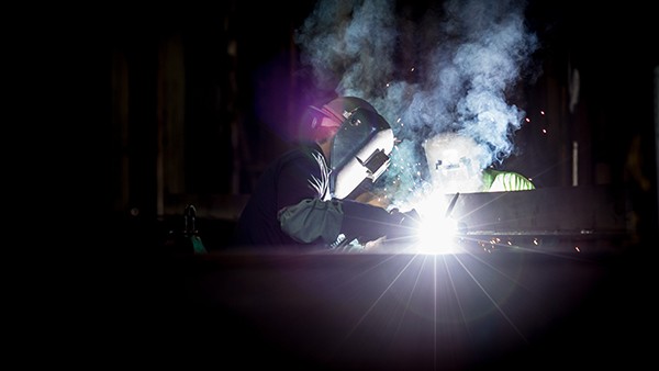 Welder wearing safety gear