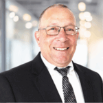 Gary Wobb smiling wearing Business attire