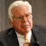 Man wearing business attire and glasses