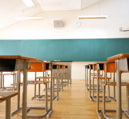 Classroom with chalkboard and rows of desks